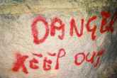A spray painted warning sign in the quarry.