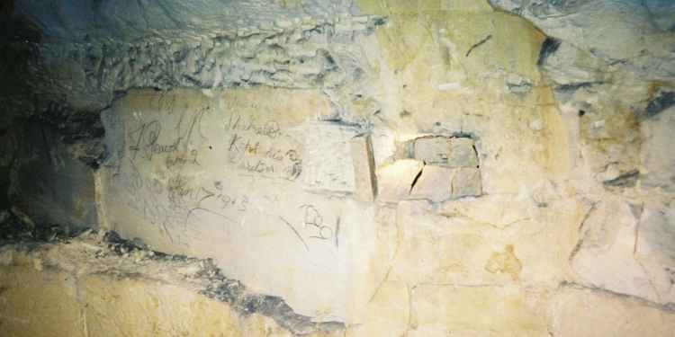 Old quarrymen's graffiti on a wall.