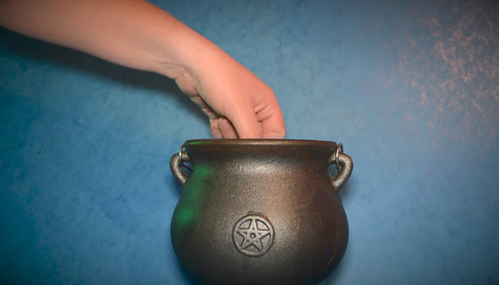Dip litmus paper into cauldron