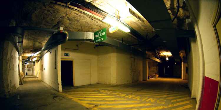 Another of the bunker's main roadways, through the door is an exit to the surface via an escalator which was requisitioned from a London underground station during WWII.
