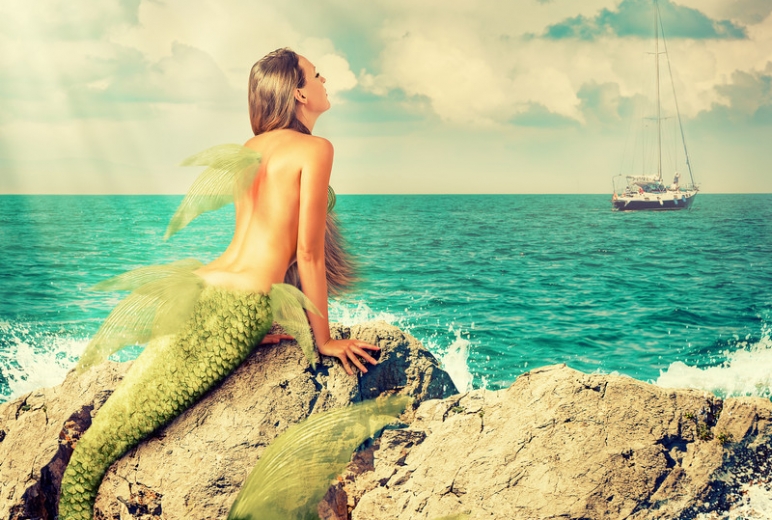Mermaid Sitting On Rocks