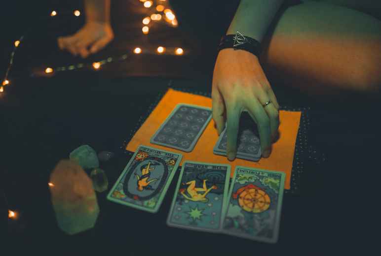 Female Fortune Teller With Tarot Cards On Table